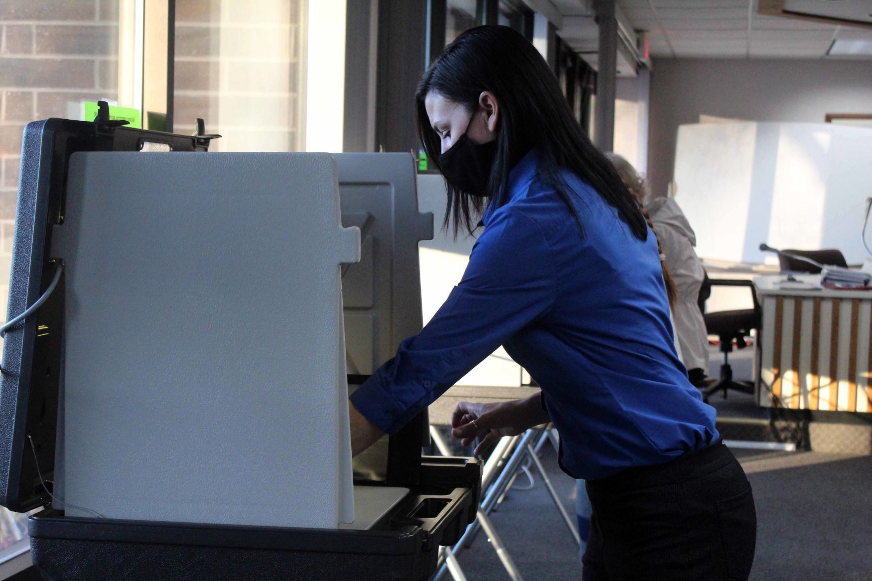 Sarah cleans booth